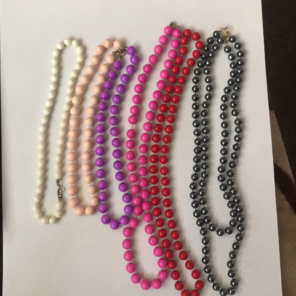 7 different color costume jewelry necklaces.